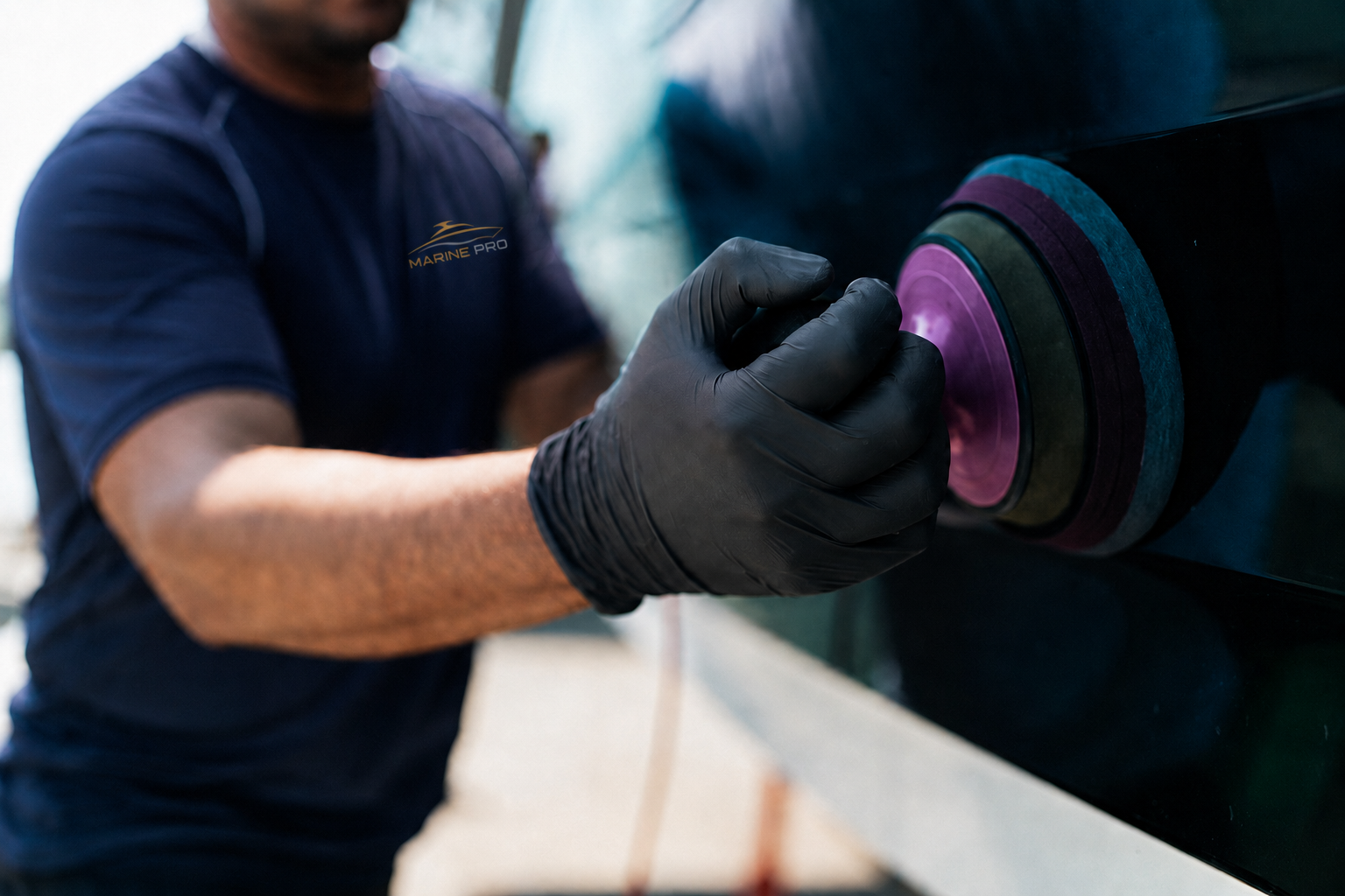 Gloved Marine PRO technician polishing a navy hull